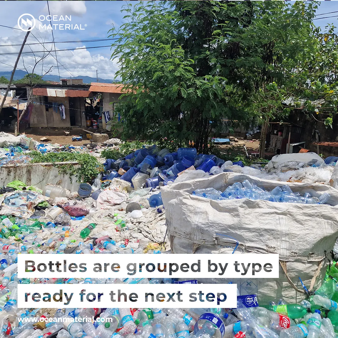 Sorted plastic bottles grouped by type at a collection site in the Philippines, prepared for the next recycling step. Visible text overlay reads: “Bottles are grouped by type – ready for the next step”