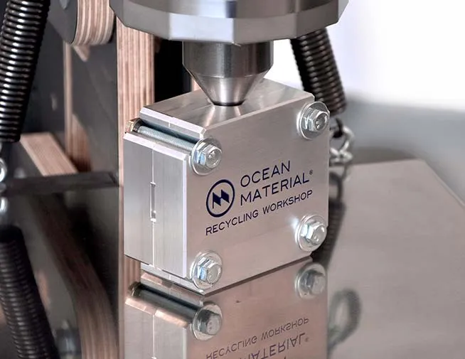 Close-up of a small press used in a plastic recycling workshop