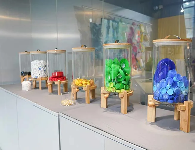 Sorted plastic caps displayed in transparent containers