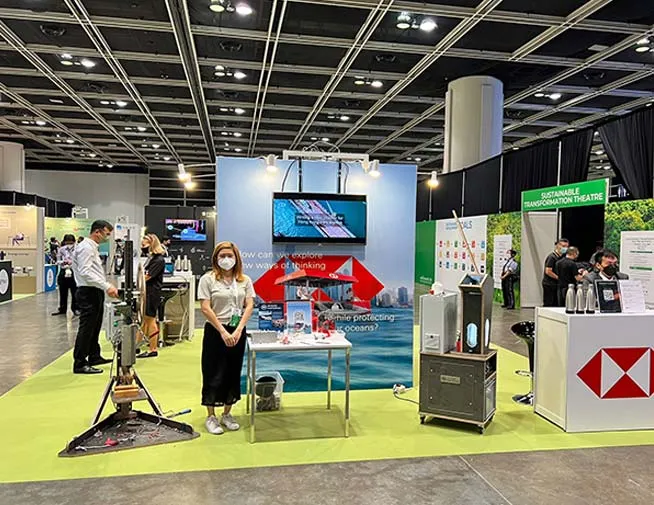 Plastic recycling exhibit with workshop equipment at a trade show
