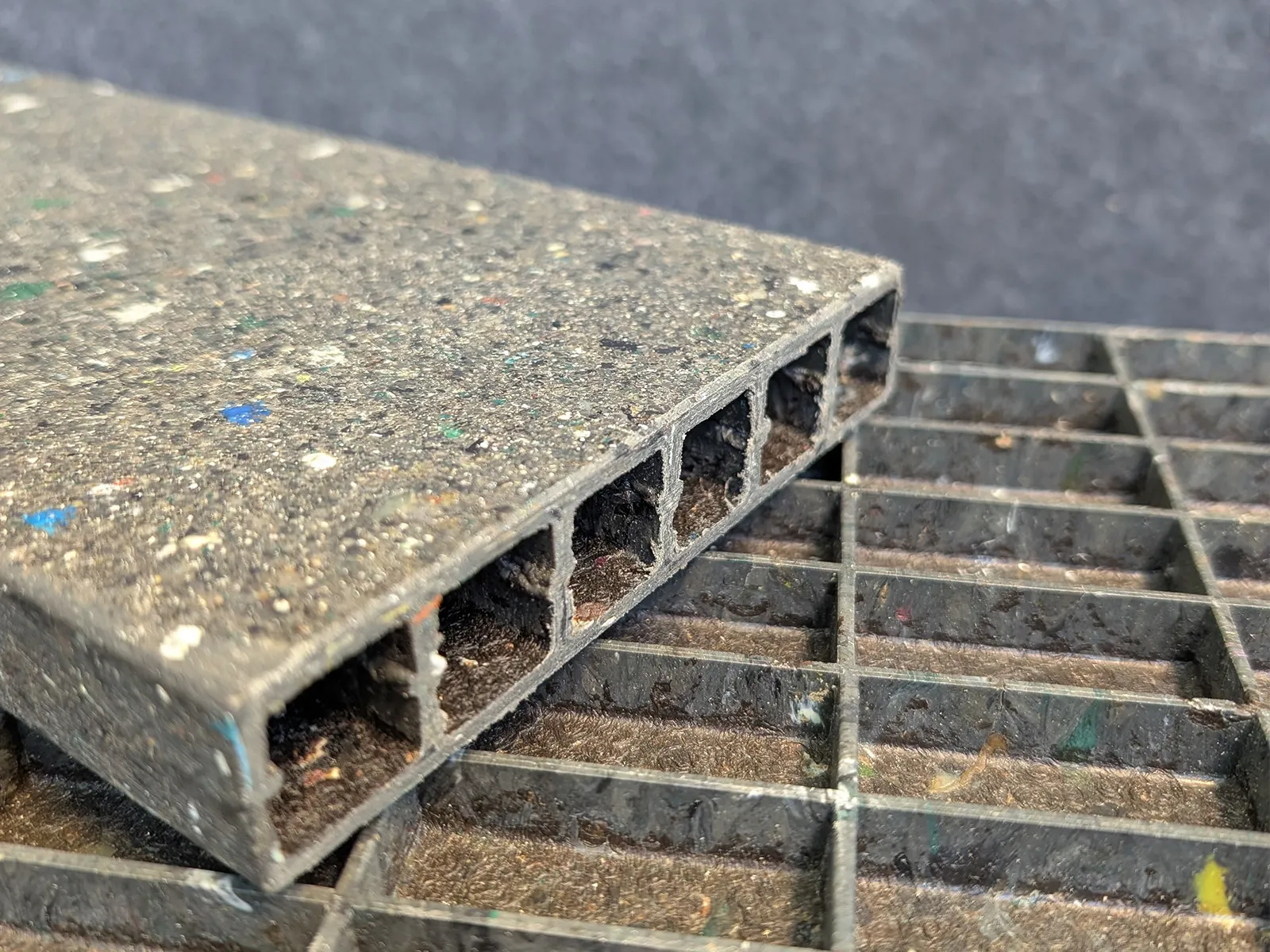 Close-up of a composite panel showing its hollow internal structure above a ribbed panel