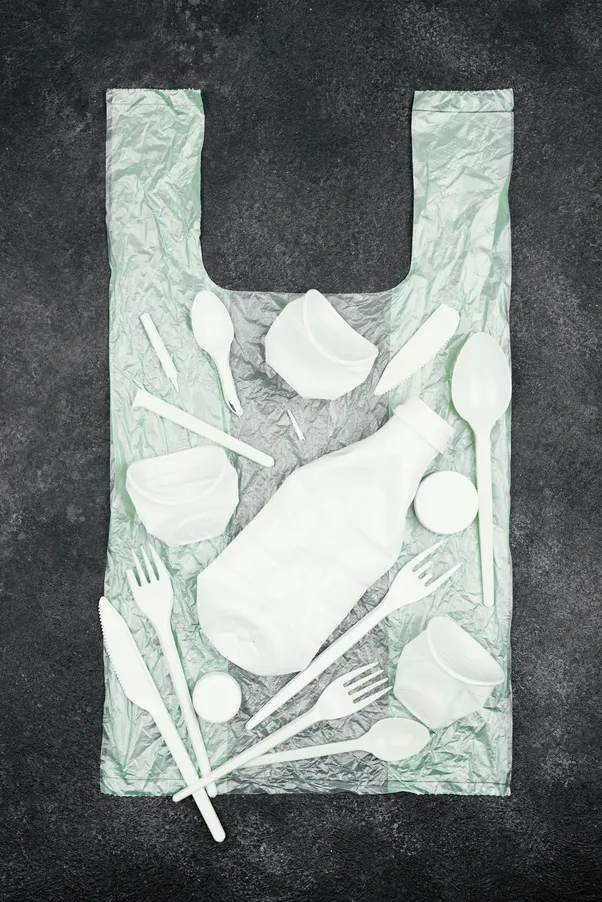 LDPE plastic bag with bottles and disposable cutlery – example of plastic recycling materials